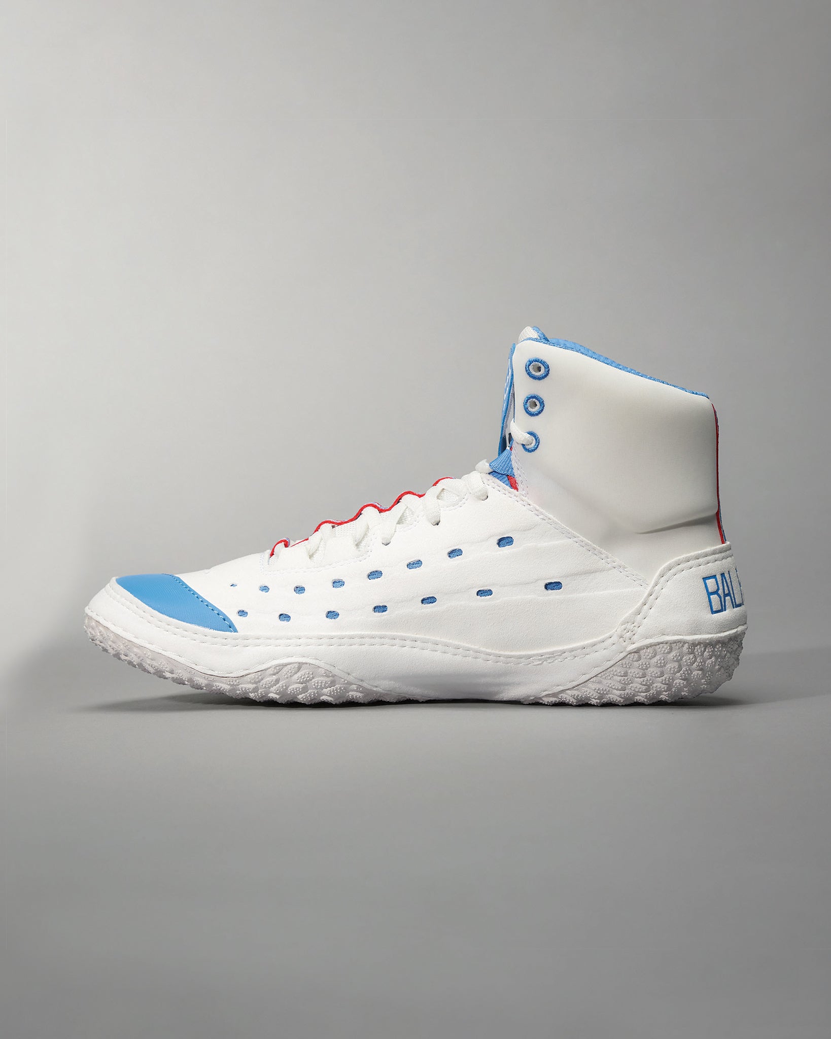 A modern white sneaker featuring blue accents red laces and a textured sole designed for performance and style