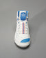 A high-top white sneaker featuring blue and red accents designed for both style and performance