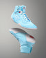 Light blue wrestling shoes with white laces on a gray background