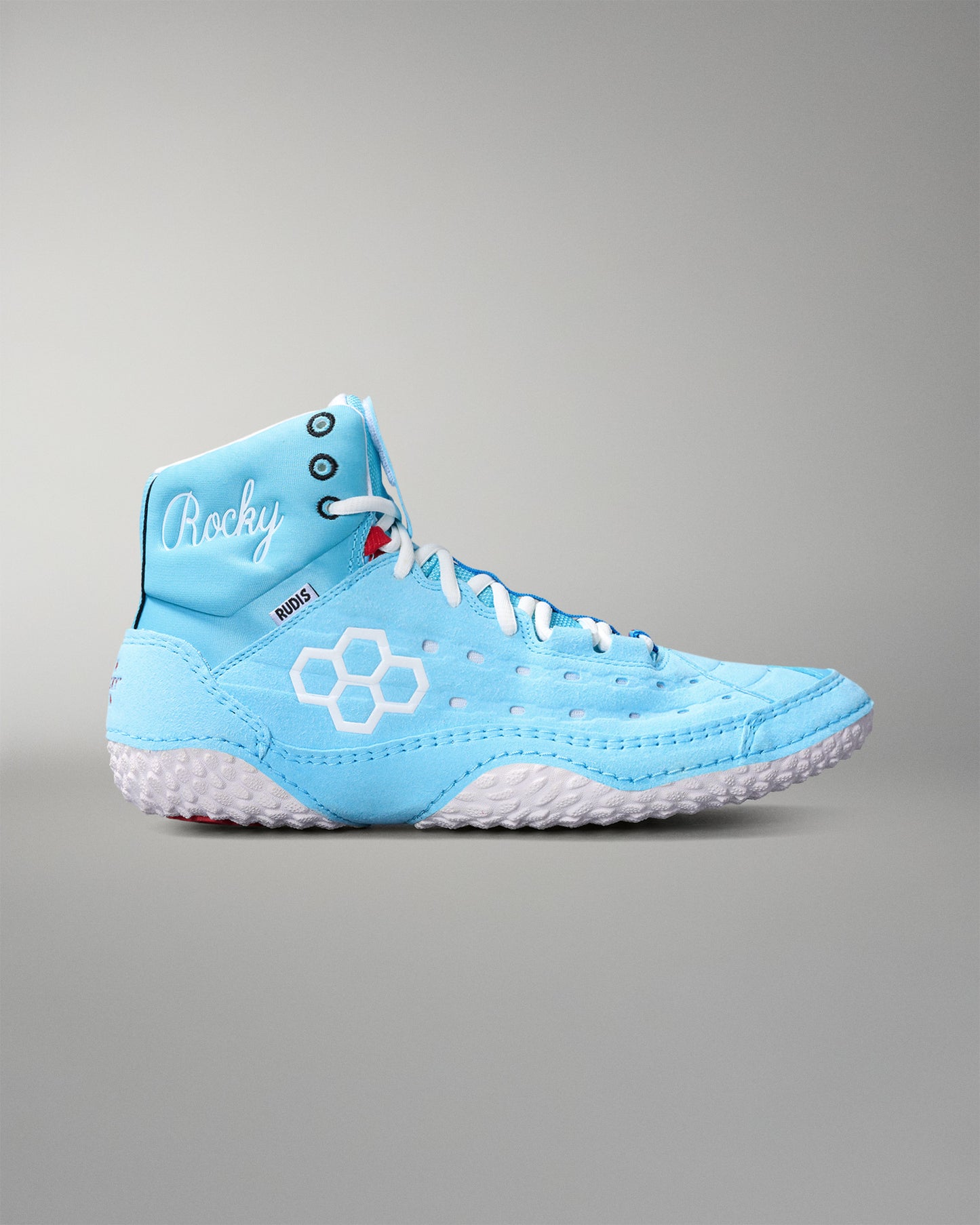 Light blue wrestling shoe with white sole on a gray background