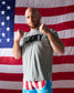 Man wearing a 'Rocky' t-shirt in front of an American flag