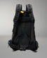 The back view of a black hiking backpack, showing the breathable mesh back panel, padded shoulder straps, and side compression buckles against a neutral gray background.