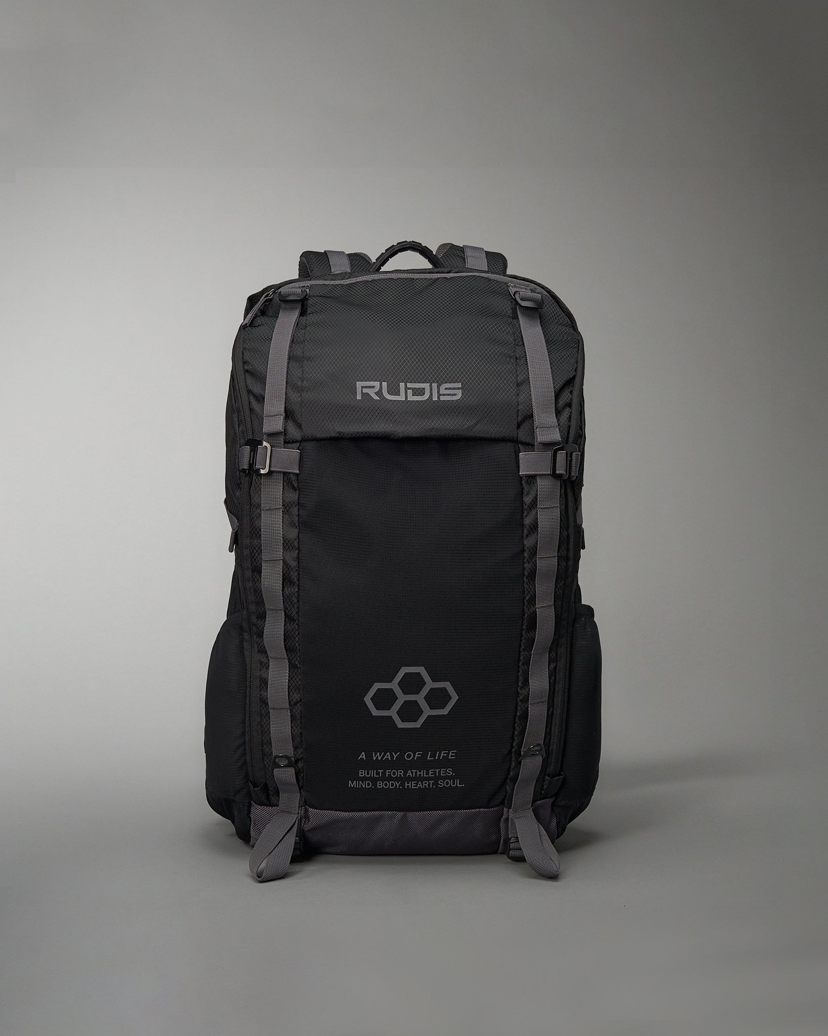 A durable black backpack designed for athletes featuring the brand name RUDIS prominently displayed and motivational text about building a healthy lifestyle