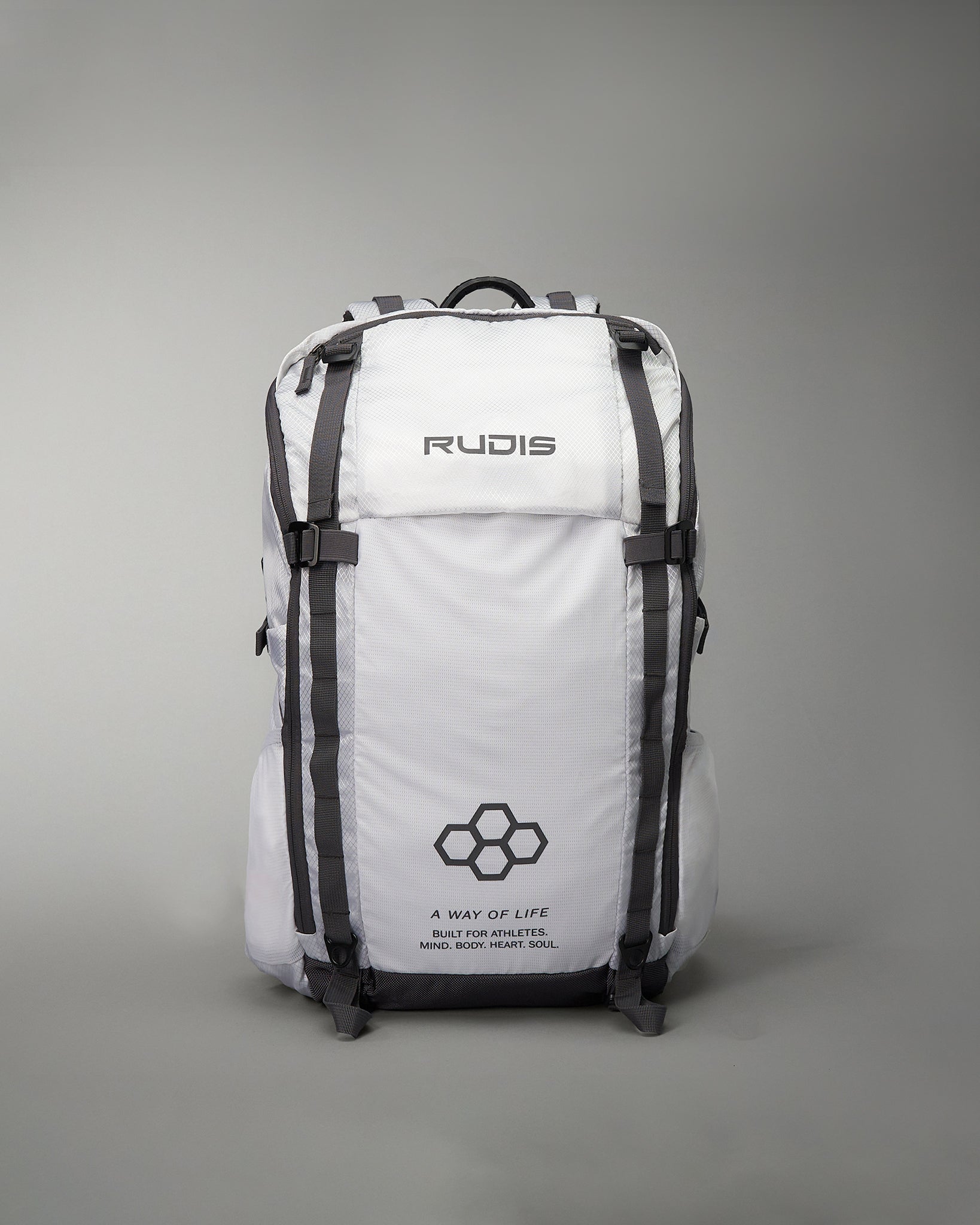 A sleek white backpack designed for athletes featuring the brand name RUDIS prominently displayed and additional motivational text emphasizing a lifestyle built for athletes