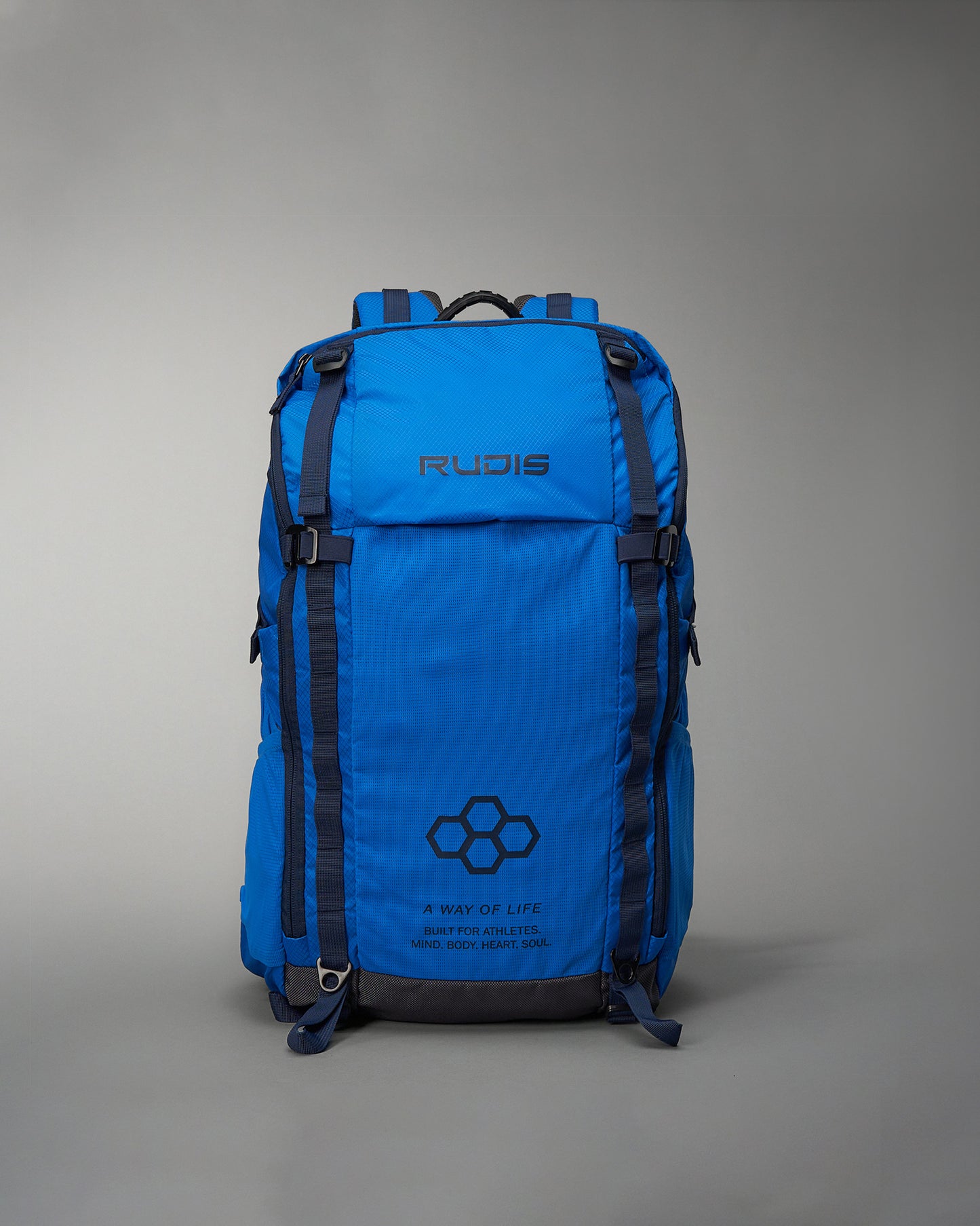 A vibrant blue athletic backpack features a sleek design with the brand name RUDIS prominently displayed accompanied by motivational text about fitness and well-being