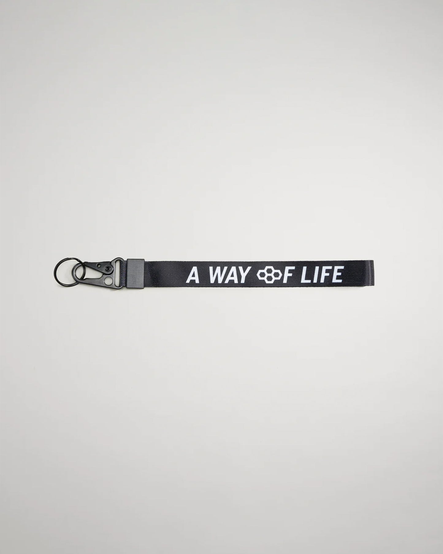 A black fabric strap featuring the phrase A WAY OF LIFE in bold white letters accompanied by a keyring attachment and clip