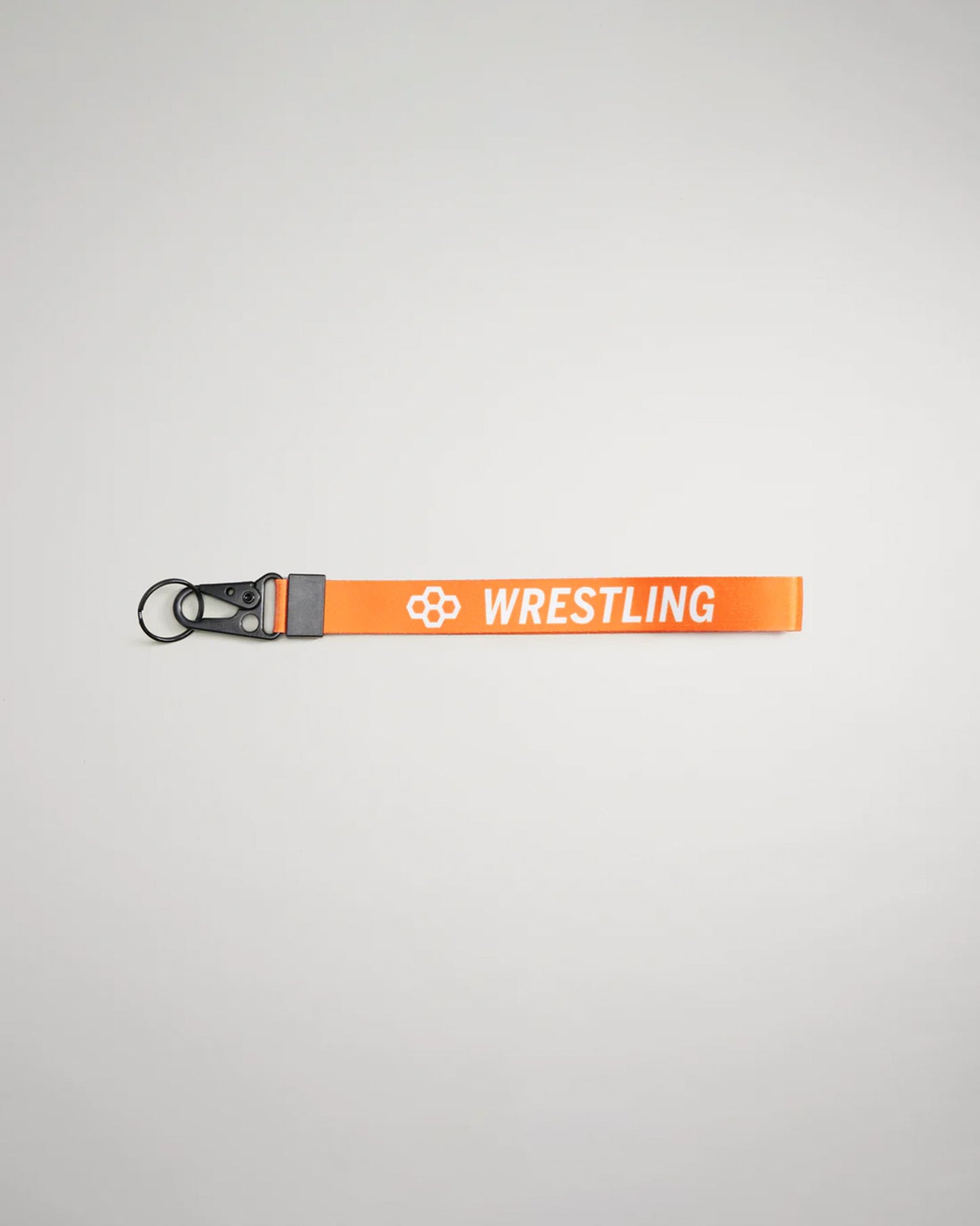 A vibrant orange lanyard with the word WRESTLING printed in bold white letters featuring a keyring and clip for securing items