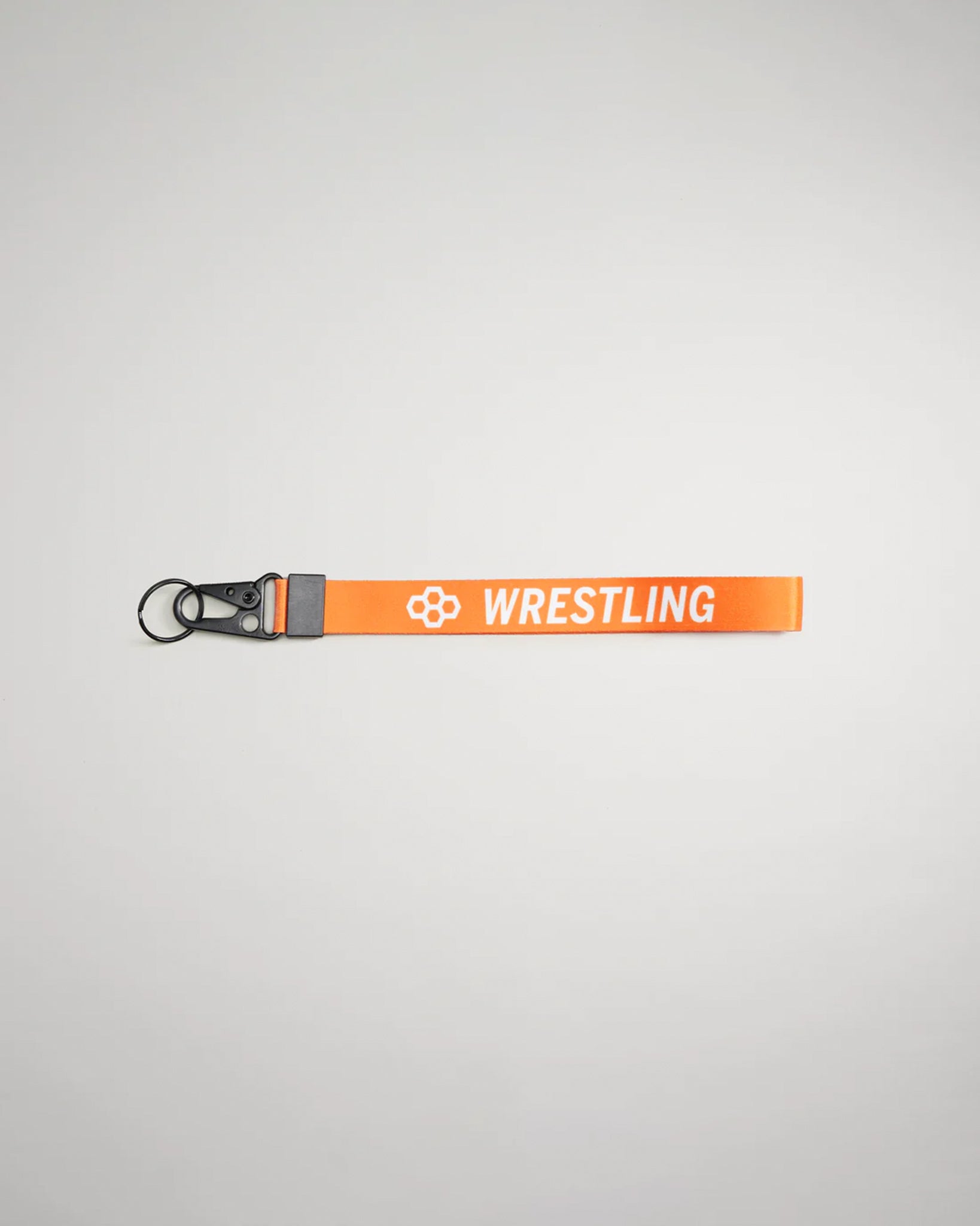 A vibrant orange lanyard with the word WRESTLING printed in bold white letters featuring a keyring and clip for securing items