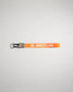 A vibrant orange lanyard with the word WRESTLING printed in bold white letters featuring a keyring and clip for securing items