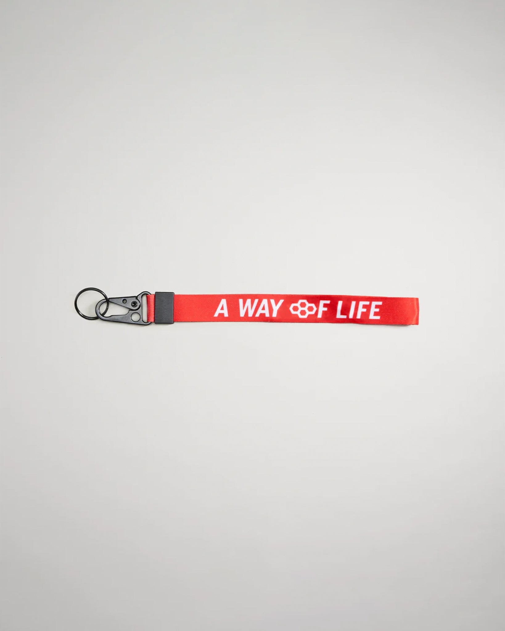A vibrant red keychain strap featuring the phrase A WAY OF LIFE in bold white lettering designed for functional and stylish use