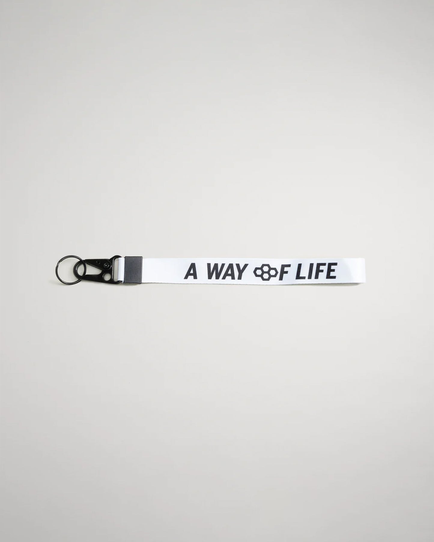 This image features a white lanyard with the text A WAY OF LIFE printed in bold black letters accompanied by a black clip and ring attachment for convenience
