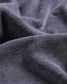 A close-up view of textured dark gray fabric showcasing its soft and plush surface characteristics