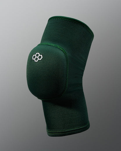 Green knee pad with a logo on a gray background