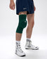 Person wearing a green knee pad on a white background