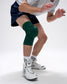 Person wearing a green knee pad on a white background