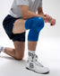 Person wearing blue knee pads on a white background