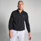 A confident male model wears a black zip-up sweatshirt with a minimalist logo paired with light gray sweatpants set against a neutral background