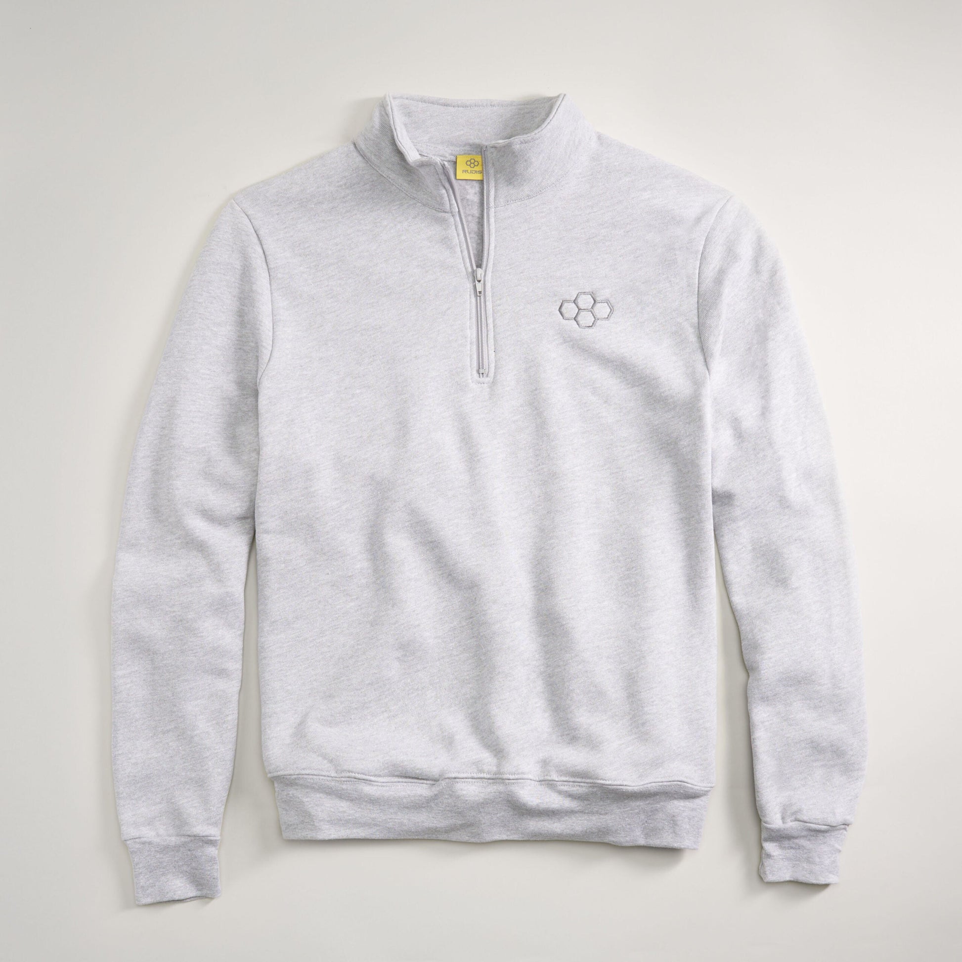 A light gray quarter-zip pullover made of soft fabric featuring a subtle logo on the chest