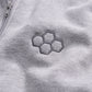 A close-up view of a light gray fabric featuring an embroidered hexagonal pattern