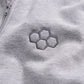 A close-up view of a light gray fabric featuring an embroidered hexagonal pattern