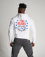 A man in a white hoodie with TEAM RUDIS printed on the back featuring a graphic design of a globe and stars paired with gray athletic pants