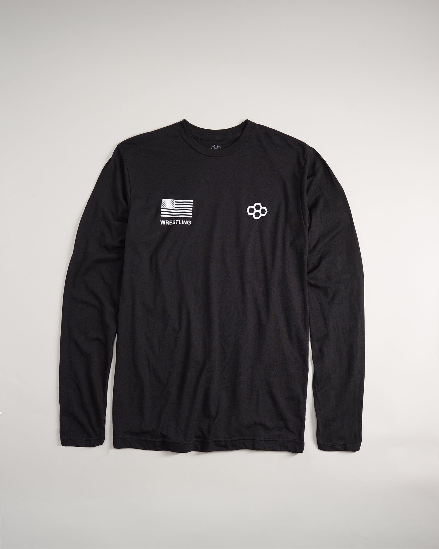 A black long-sleeve shirt featuring an American flag patch and WRESTLING text complemented by a stylized logo on the opposite side