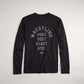A black long-sleeve t-shirt featuring the text WRESTLING followed by MIND BODY HEART SOUL in a bold curved layout with a red logo at the bottom
