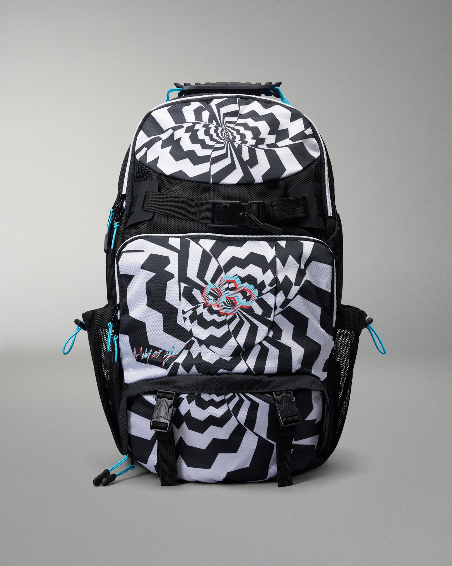 A black and white patterned backpack with a spiral optical illusion design, featuring a central butterfly graphic and bright blue zipper pulls, shown on a neutral gray background.
