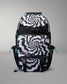 A black and white patterned backpack with a spiral optical illusion design, featuring a central butterfly graphic and bright blue zipper pulls, shown on a neutral gray background.