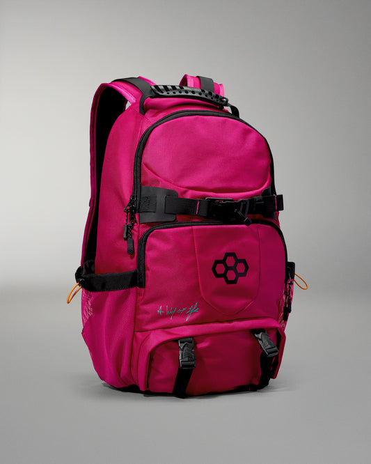 Pink backpack with black straps on a gray background