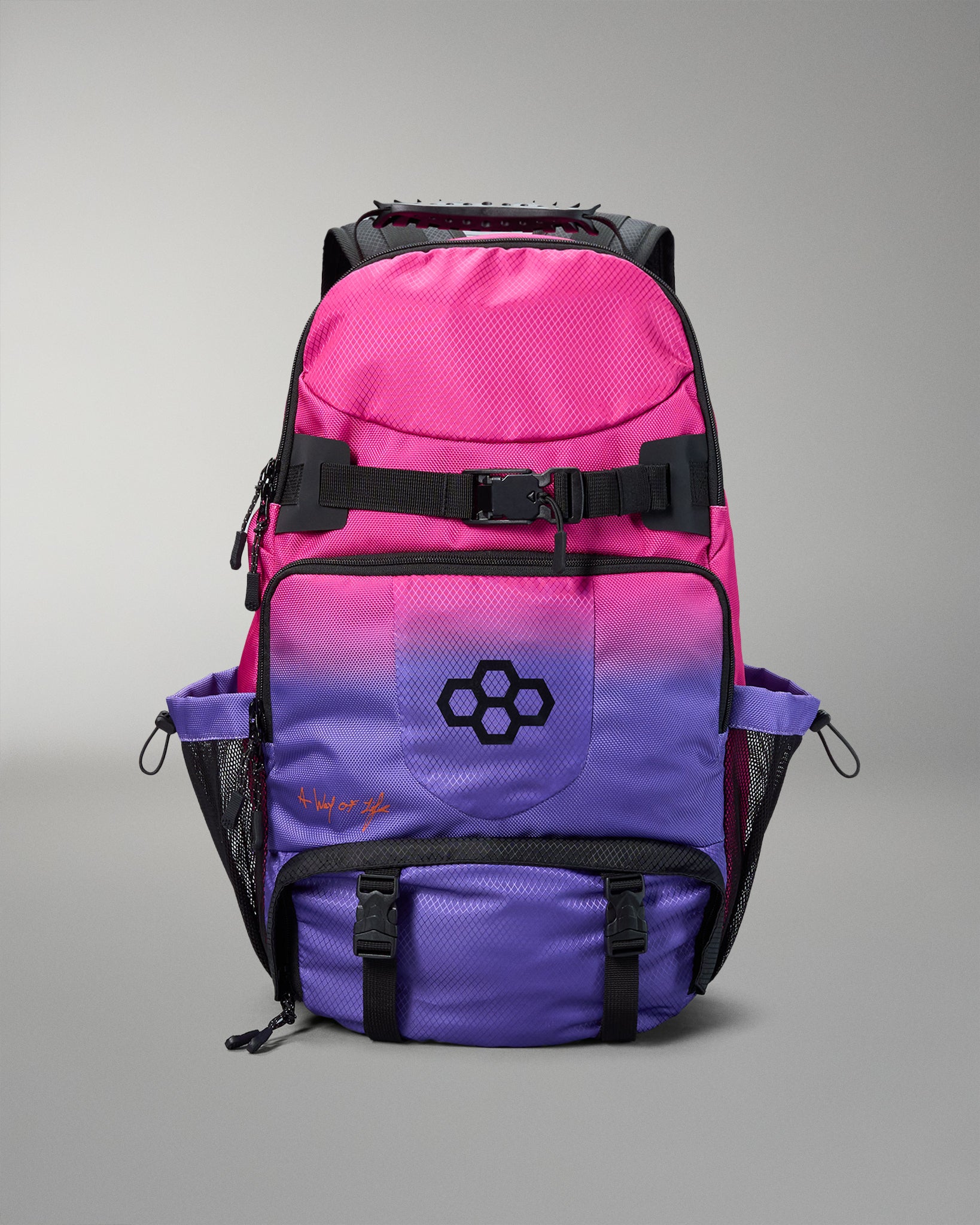 Pink and purple backpack with a logo on a gray background
