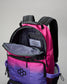 Pink and purple backpack with open front pocket on a gray background