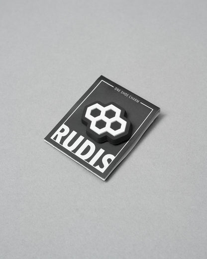 Black card with a white hexagonal symbol and 'RUDIS' branding on a gray background