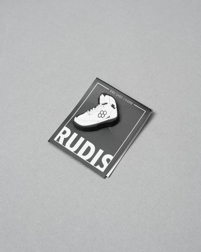 White shoe charm on a RUDIS branded card against a gray background