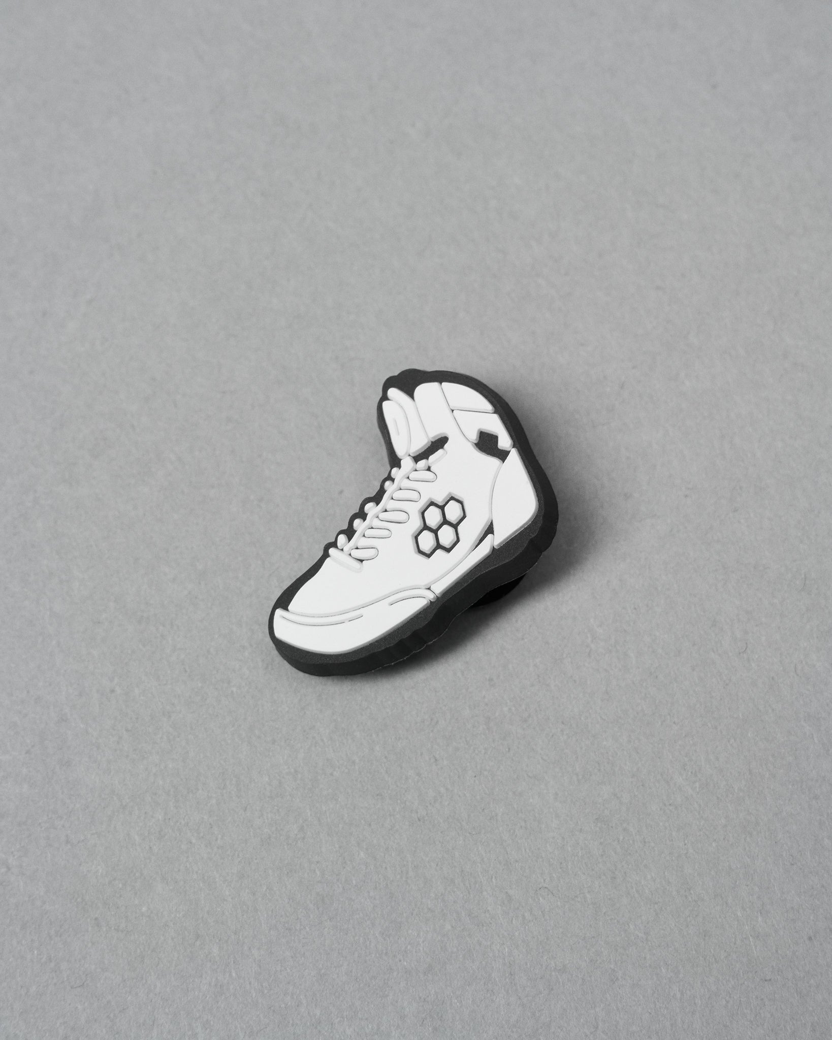 White sneaker with black accents on a gray background