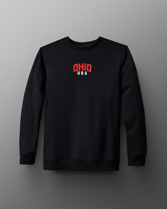 Front view of the RUDIS Team Ohio Arched Crewneck in black, featuring a small red and white 'OHIO USA' graphic centered on the chest, with a clean, minimalist design.