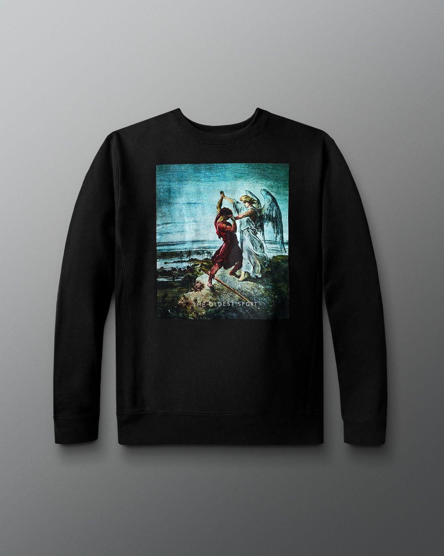 A black crewneck sweatshirt is displayed against a gray background. The front features a printed artwork depicting the biblical scene of Jacob wrestling an angel, set against a scenic, cloudy backdrop. Beneath the image, small text reads “THE OLDEST SPORT.” The sweatshirt has a relaxed fit with ribbed cuffs and hem.