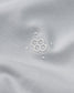 Close-up of a white fabric with a subtle logo on a light gray background