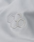 Close-up of a white fabric with embroidered hexagonal pattern