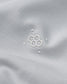Close-up of a white fabric with a subtle logo on a light gray background