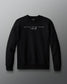 Black sweatshirt with text on a gray background. 