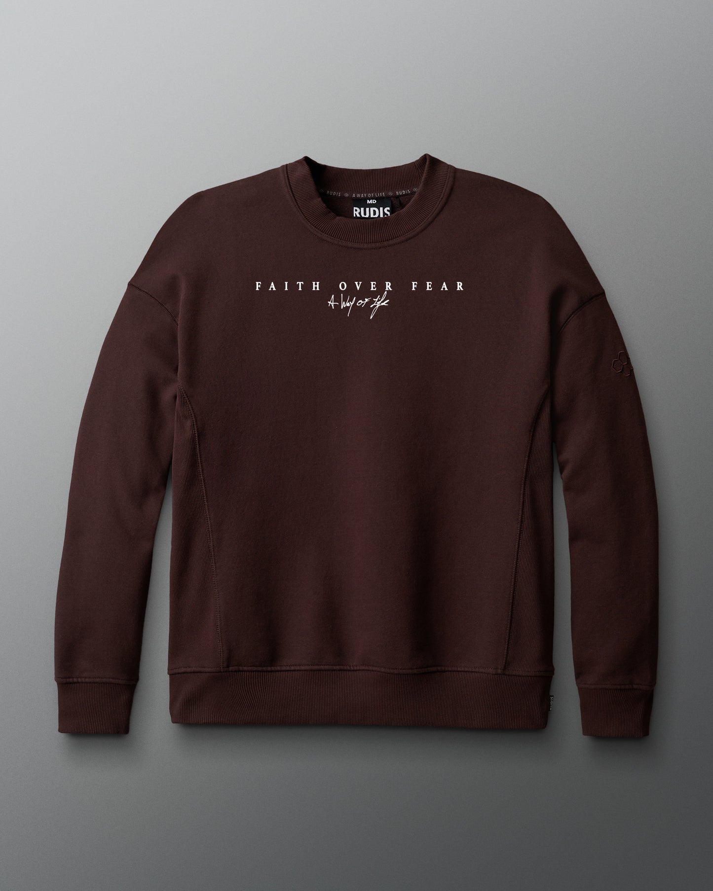 Brown sweatshirt with 'Faith Over Fear' text on a gray background