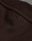 Brown fabric with 'RUDIS' branding on a dark background