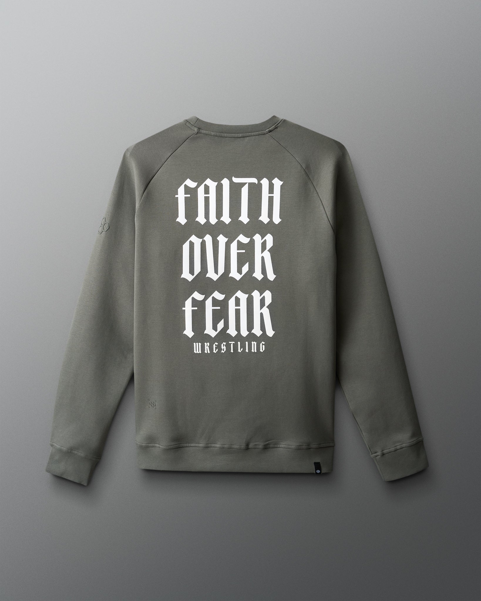 Gray sweatshirt with 'Faith Over Fear Wrestling' text on the back against a gray background