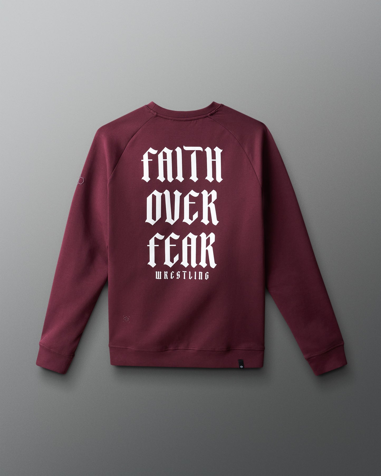 Maroon sweatshirt with 'Faith Over Fear Wrestling' text on a gray background