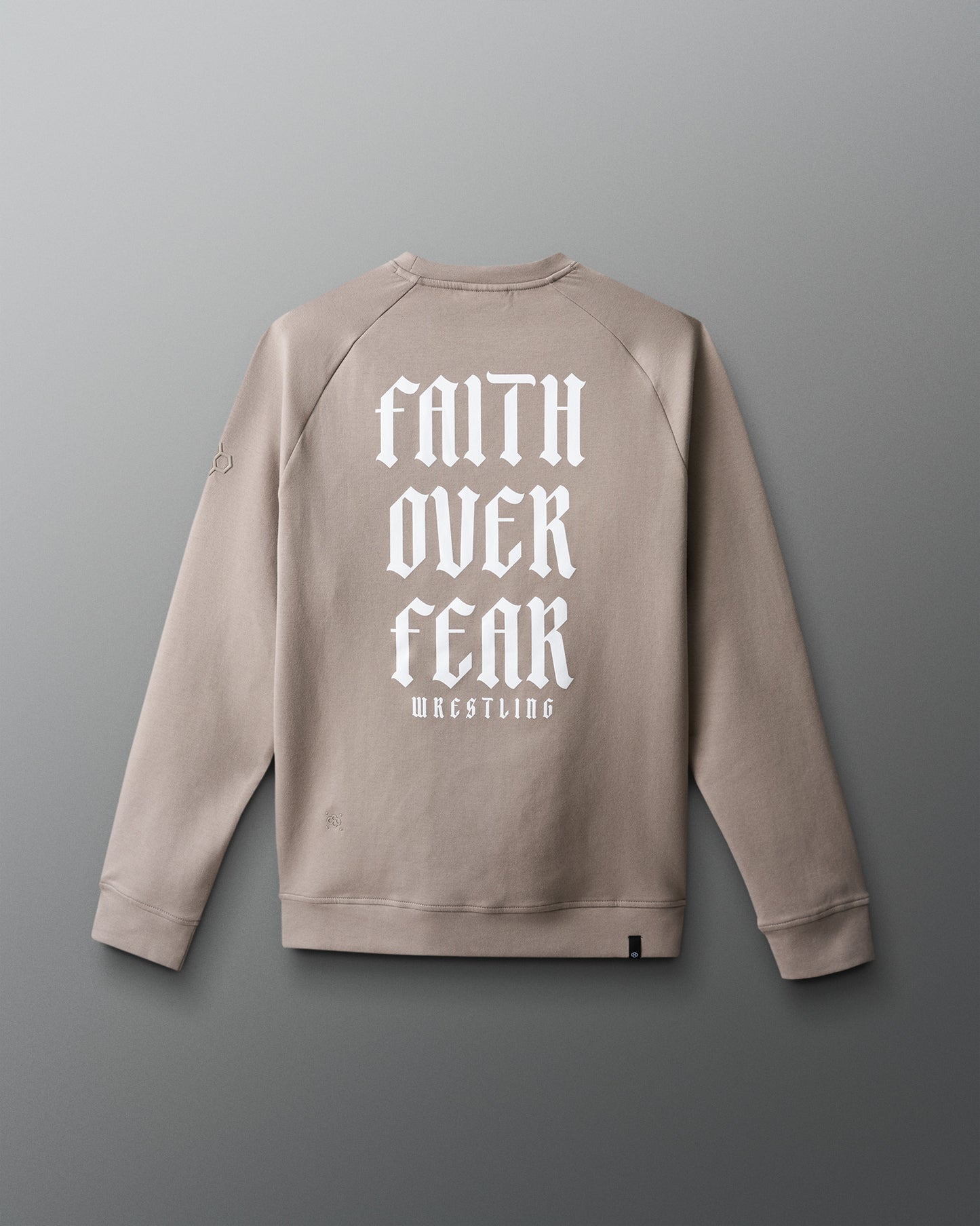 Beige sweatshirt with 'Faith Over Fear Wrestling' text on the back against a gray background