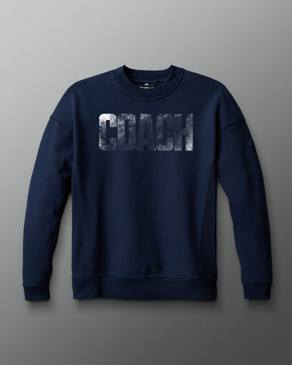 Navy blue sweatshirt with 'COACH' print on a gray background