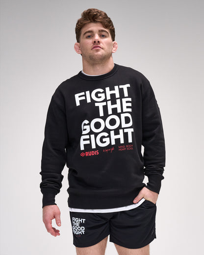 Man wearing a black crewneck with 'Fight The Good Fight' text on a gray background