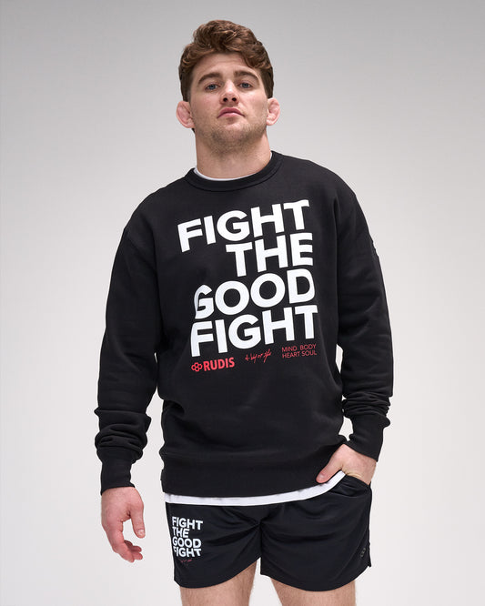 Man wearing a black crewneck with 'Fight The Good Fight' text on a gray background