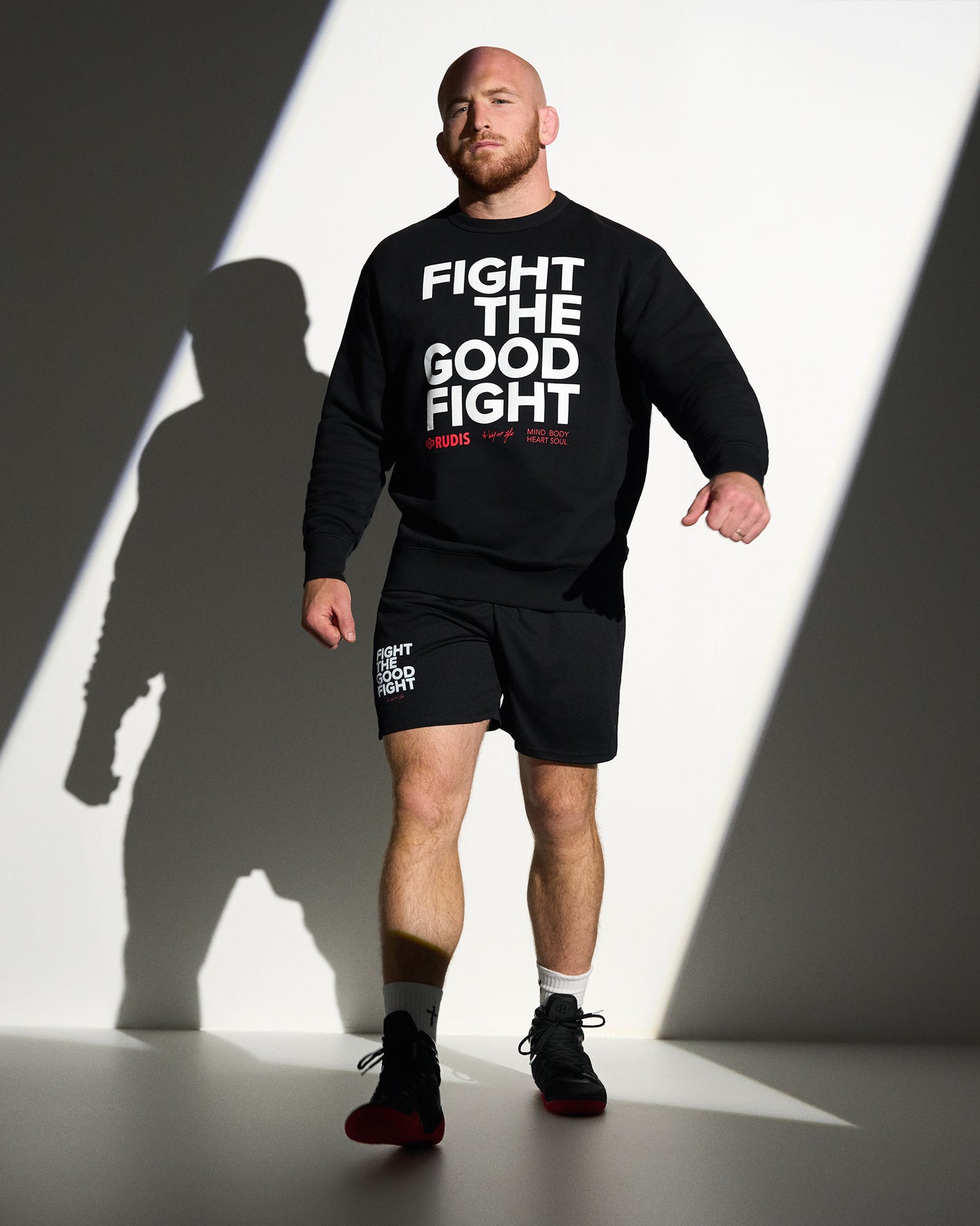 RUDIS Fight the Good Fight Comfort Fleece Crewneck in black, featuring a bold front graphic, premium fleece fabric, and an athletic fit designed for everyday comfort and the wrestling lifestyle.